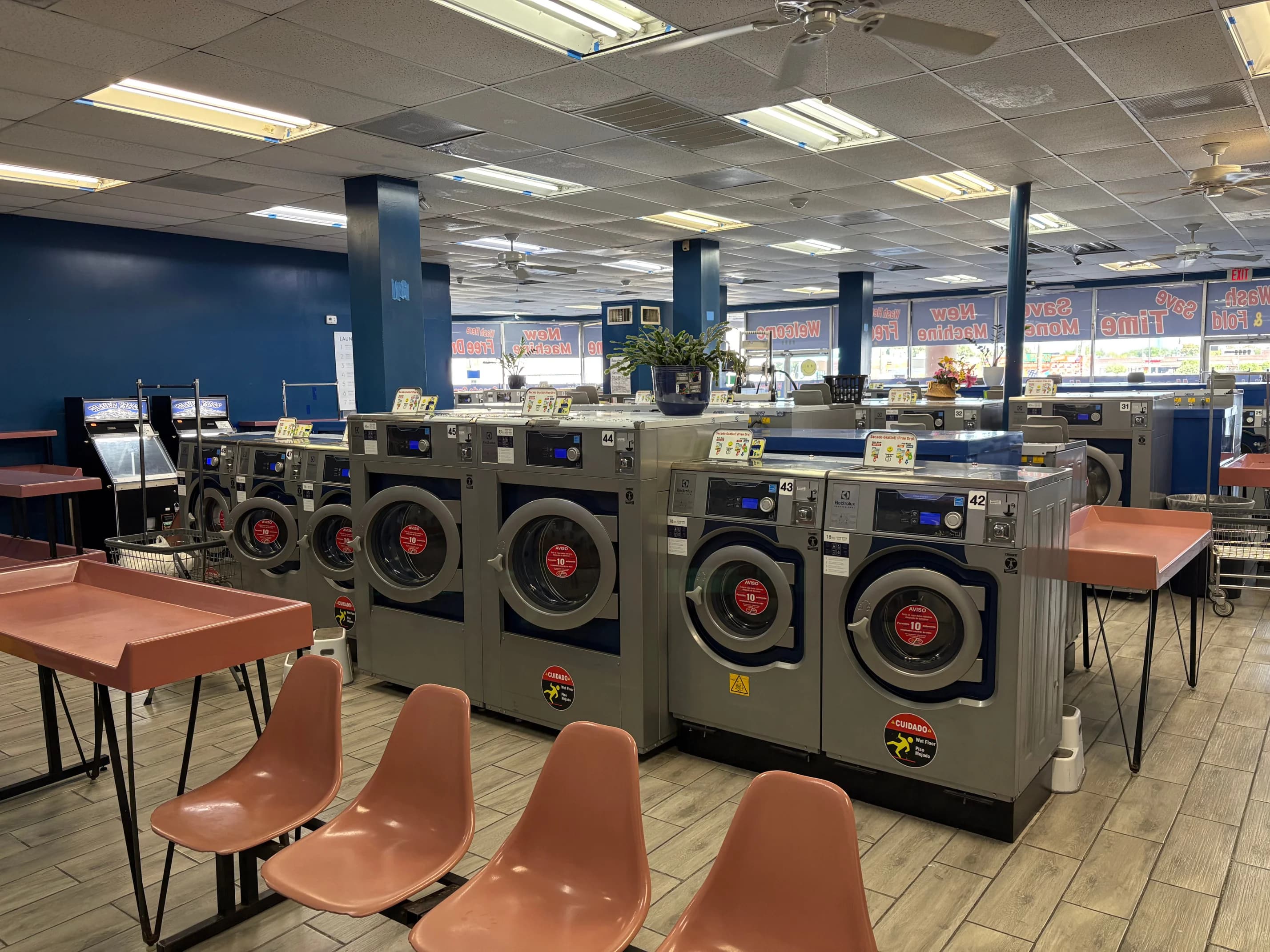 Modern self-service laundry machines inside the washateria